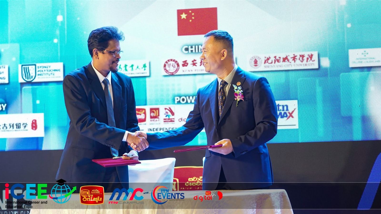 Partners shake hands after signing